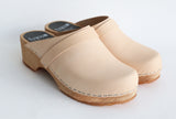 a pair of closed toe shoes with natural leather upper and wooden base