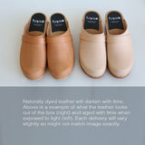 two pairs of closed toe shoes with wooden bases and natural leather